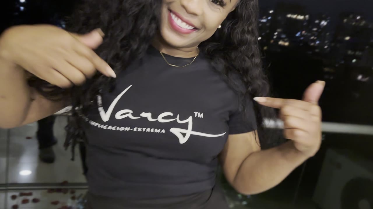 Adult woman wearing a black Narcy T-shirt at night