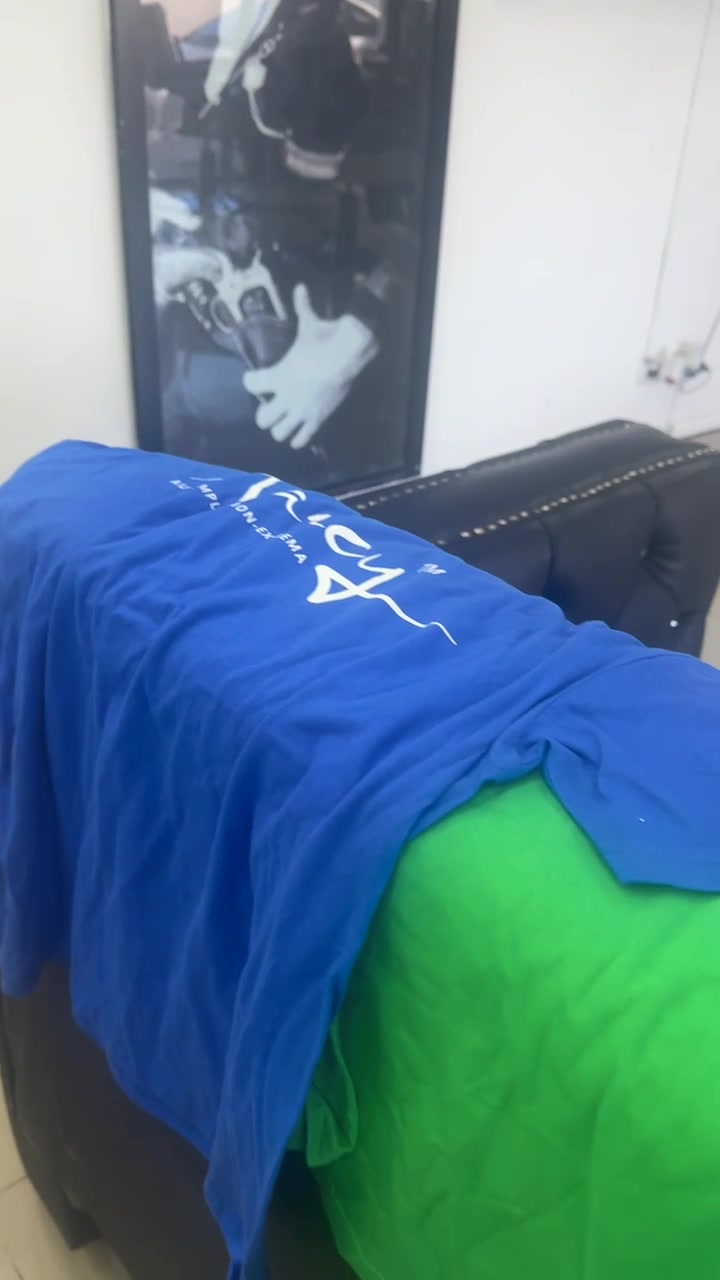 Two folded Narcy logo tees displayed on a black seat