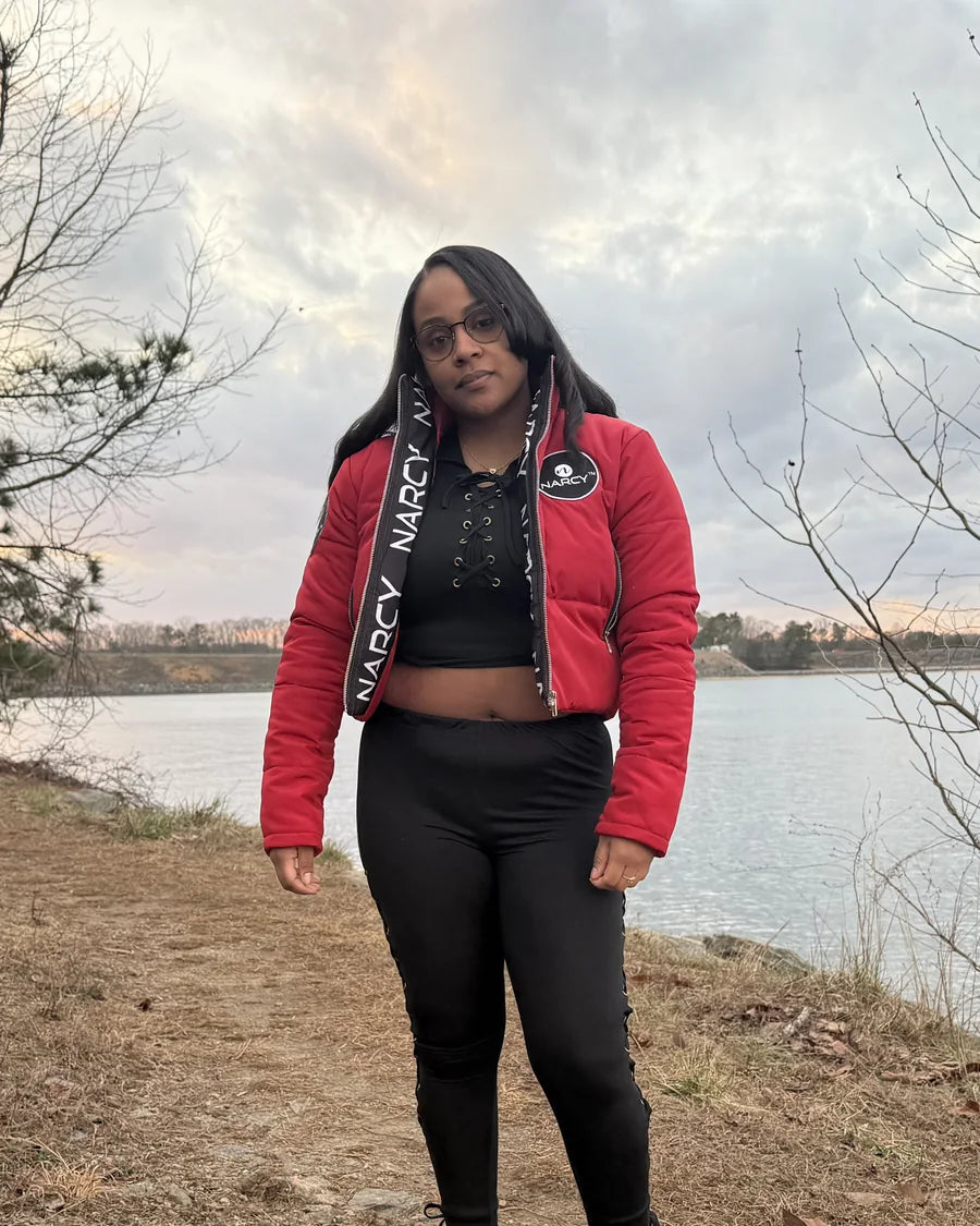 Adult woman wearing red Narcy outerwear by a lake
