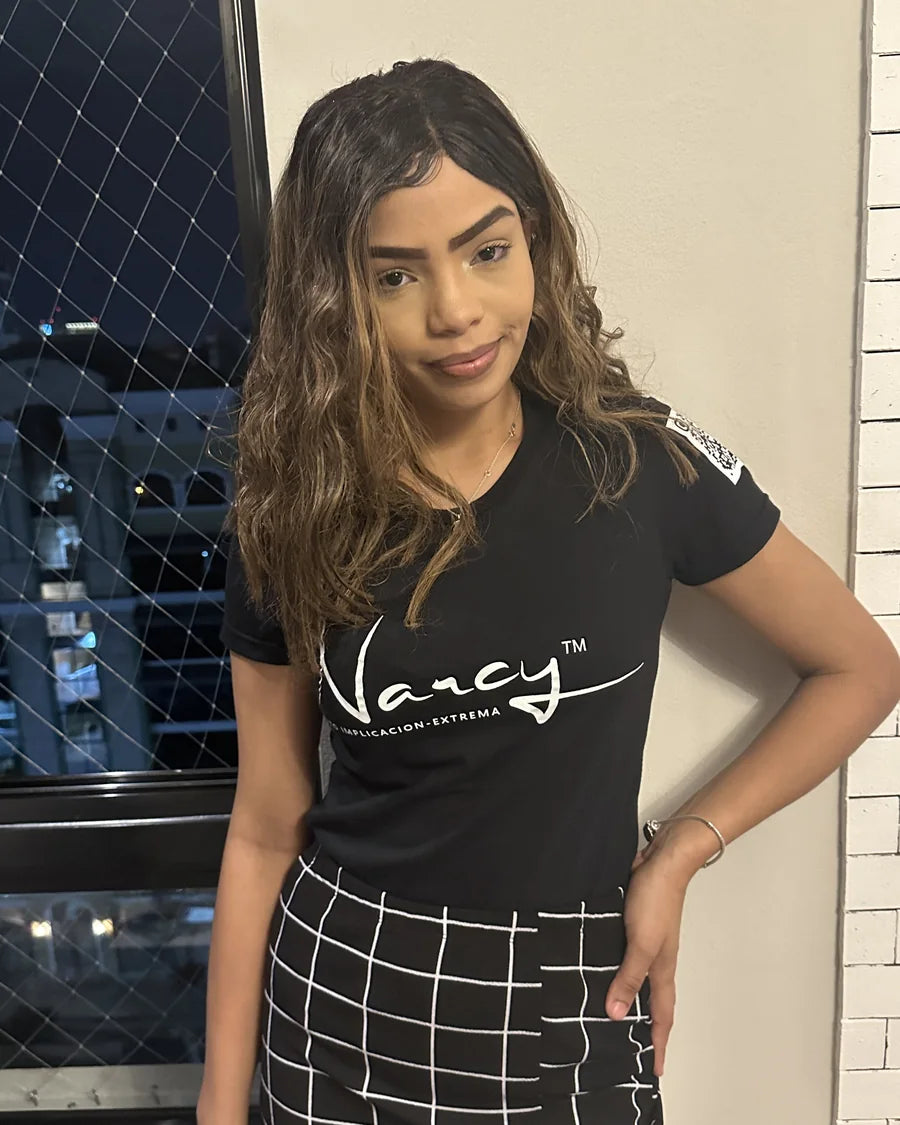 Adult woman wearing a black Narcy wordmark T-shirt in an indoor editorial portrait